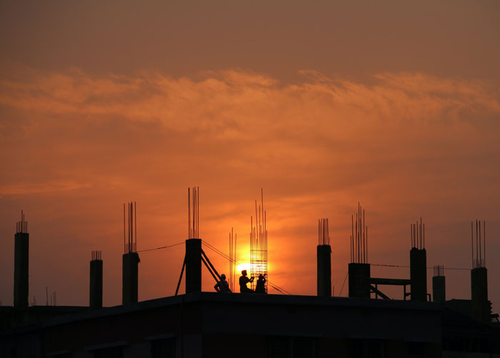 Construction site in silhouette at sunset