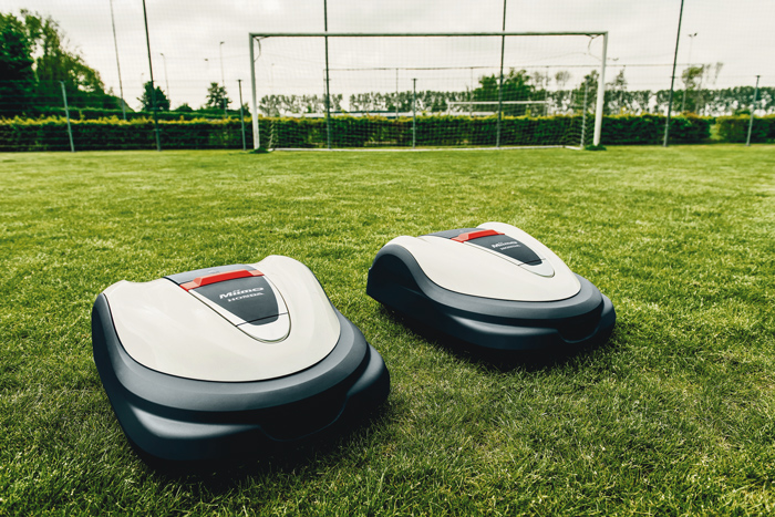 Two Honda Multi Miimo robots on a football pitch