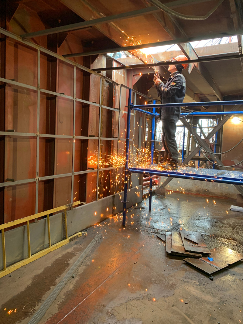 Canva - Welder working inside industrial building