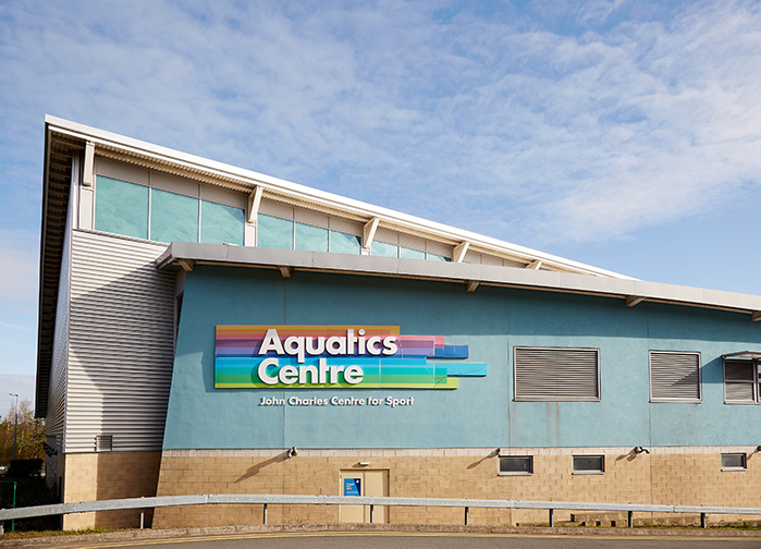 John Charles Centre For Sport, Aquatics Centre building against blue skyline