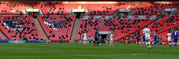 A football match at Wembley Stadium being watched by a social-distant crowd