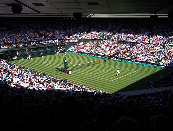 A crowd watching a tennis match at Wimbledon