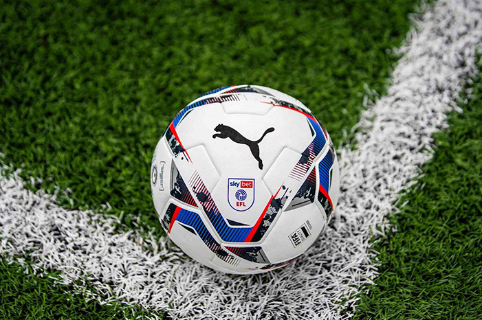 An EFL football on the corner of a football pitch