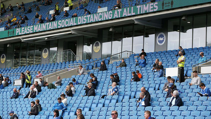 Fans at the Amex socially distancing during a football match