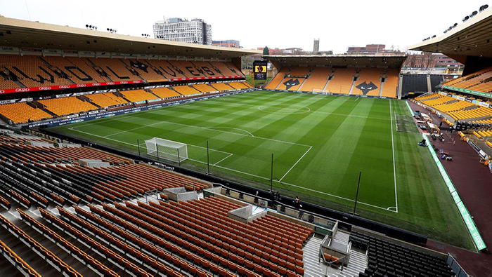 A photo of the football pitch and seats inside Wolves' Molineux Stadium