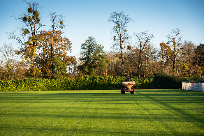 A groundsman working on a pitch