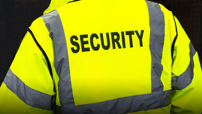 A security guard wearing a high-vis vest