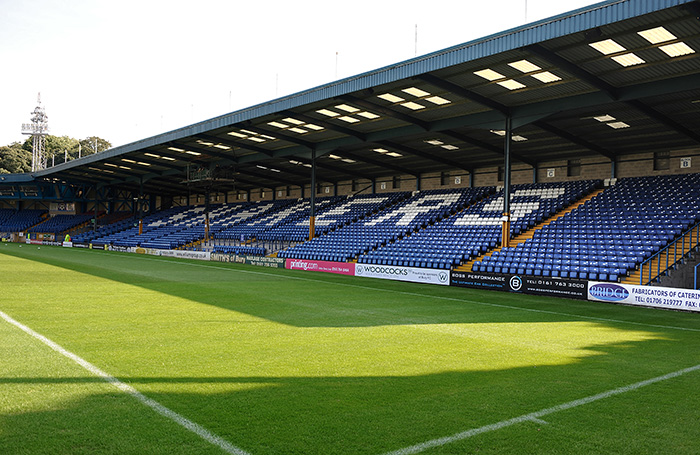 inside Gigg Lane stadium, looking at the seating and football pitch