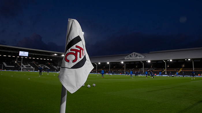 A football match held at night at Craven Cottage, Fulham Football Club