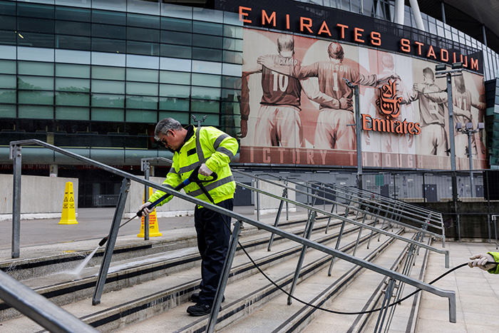An Atlas FM cleaner power-cleaning the steps at Arsenal Stadium