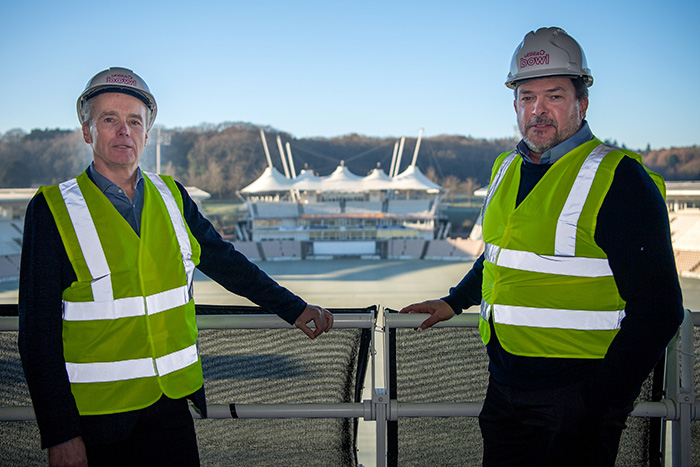David Mann and Bill Bullen wearing hardhats and high-vis vests, in front of the Utilitia Bowl