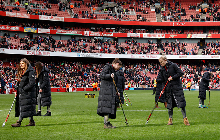 Female groundstaff raking the pitch at the Emirates Stadium for Arsenal vs Tottenham in the Barclays Women’s Super League