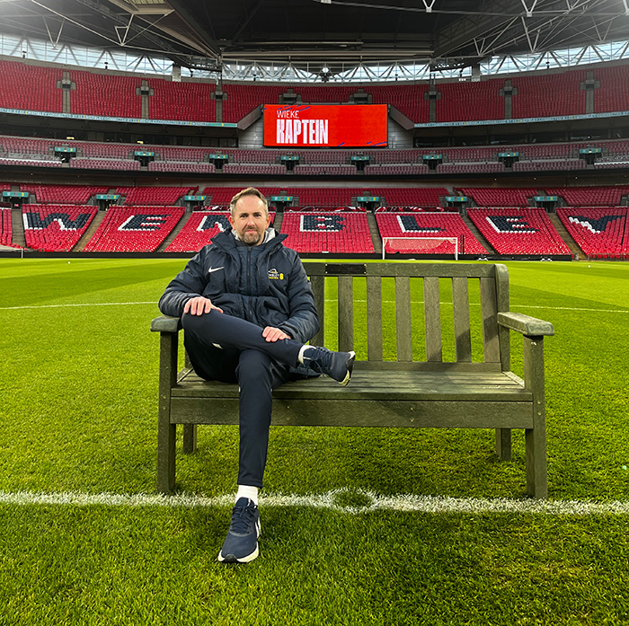 Karl Standley, Grounds Manager at Wembley Stadium, sat on the recycled bench