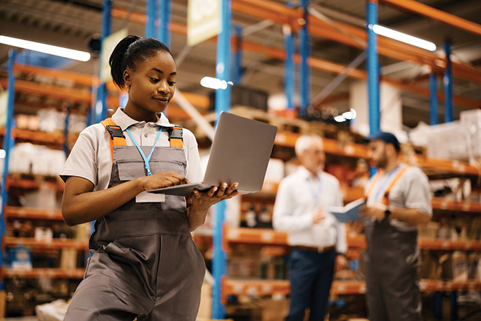 A woman using a computer in a distribution centre