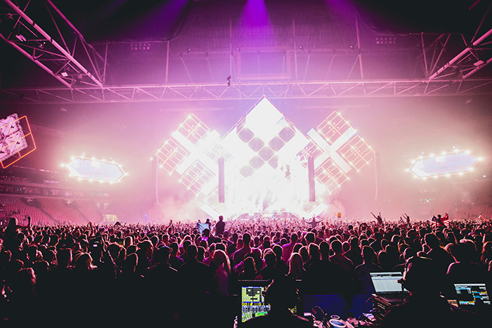 An energetic crowd at a concert in a music venue