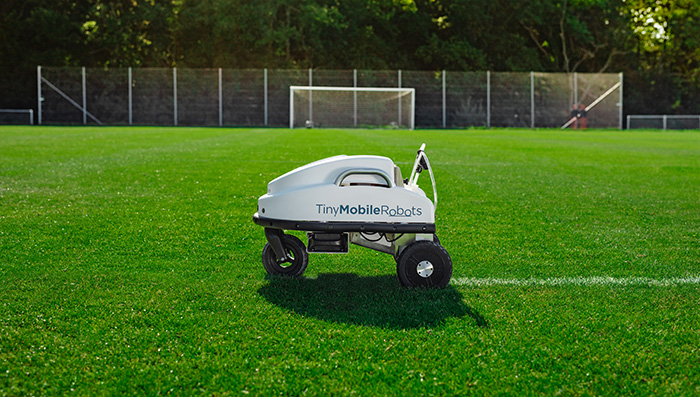 TinyLineMarker Robot from Origin Amenity Solutions making a line on a football pitch