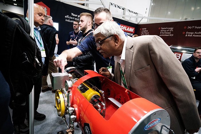 An EMEX attendee inspecting an exhibitors equipment