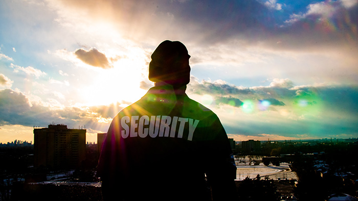 A security guard wearing a high-vis jacket