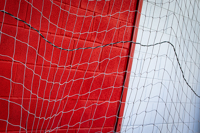 A wall at FC United painted red and white with HydroPro Masonry Paint