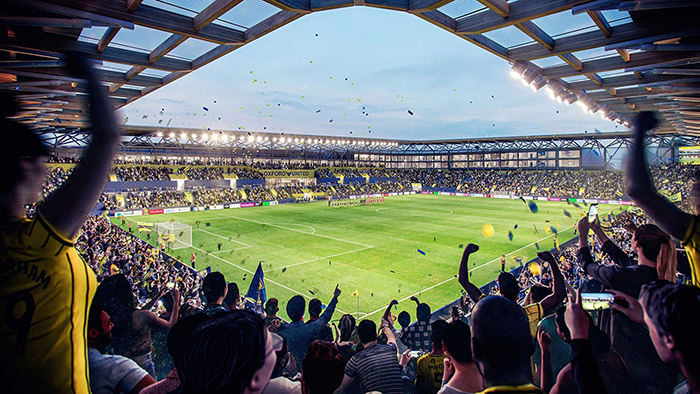 fans cheering a football match at OUFC's new stadium