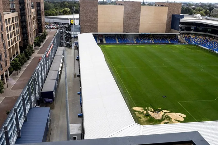 An aerial view of the sinkhole, viewing for the stadium for a sense of scale