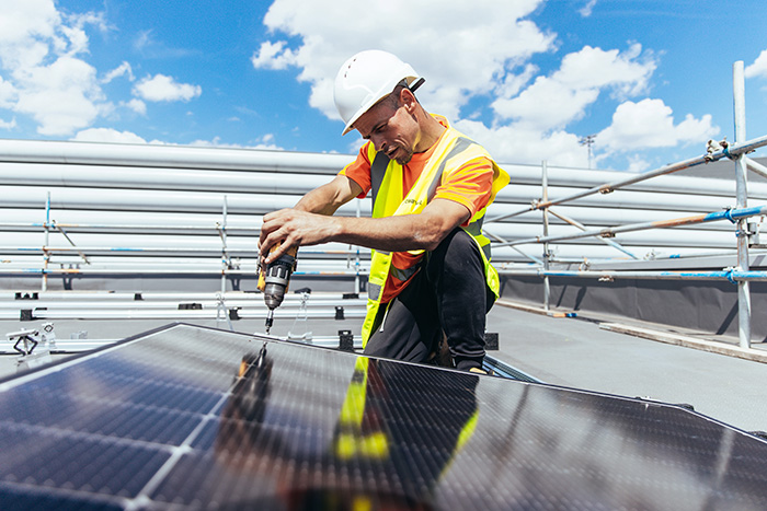 A worker installing a solar panel