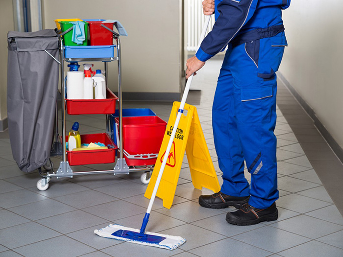 A cleaner sweeping a floor