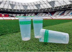 three plastic cups on a football pitch